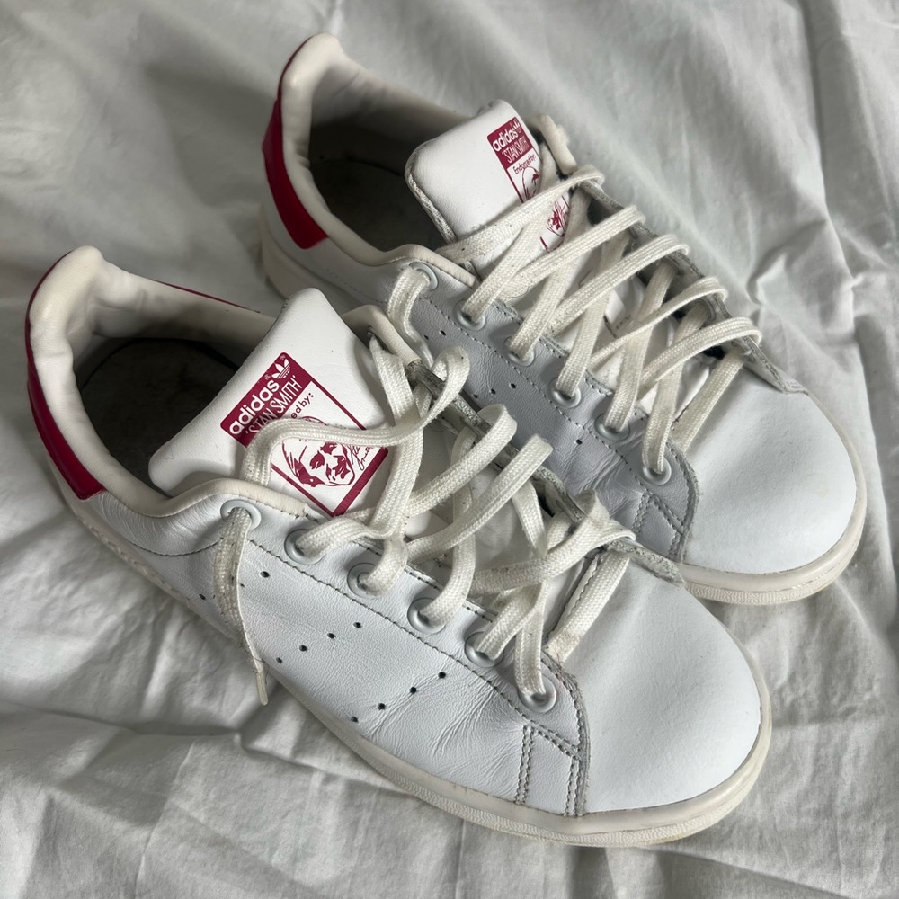 Classic white Adidas Stan Smith trainers with pink accents